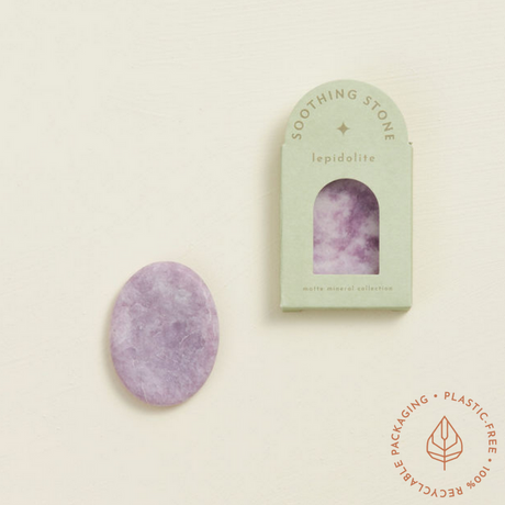 Soothing Stone | Lepidolite with a soft matte finish and oval shape, displayed next to its eco-friendly packaging.