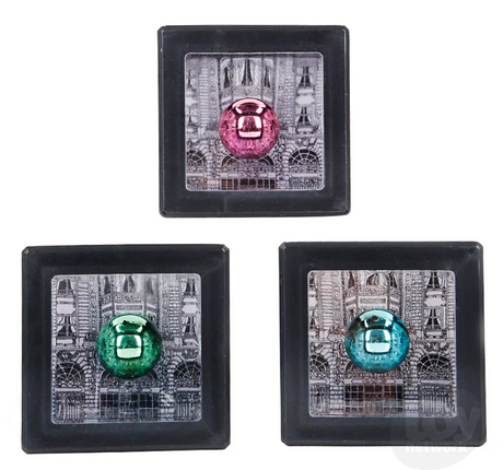 Three Magic Cash Box toys in assorted colors showing coin slots with a Parisian building design background.