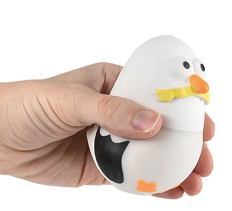 Hand squeezing the Squish & Stretch Seagull fidget toy for stress relief and sensory play.