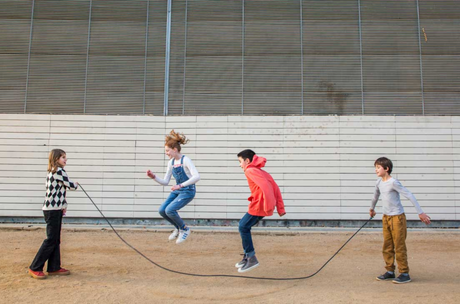 Jump Rope | Playground Coral & Mint used by children playing outdoors, featuring long cotton rope and wooden handles.