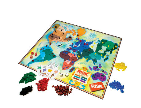 Risk 1980's Edition board game with colorful territories, plastic armies, cards, dice, and game box displayed.