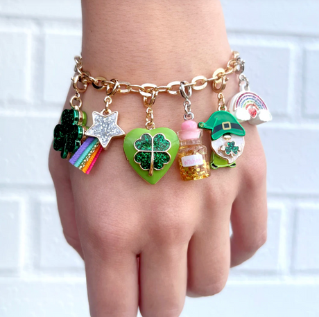 Gold Luck Locket Charm shown on a gold bracelet with colorful lucky and festive enamel charms.