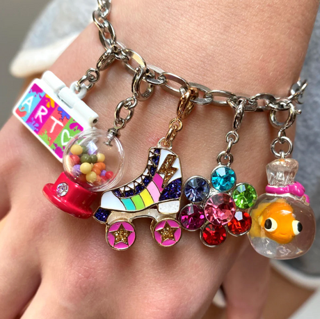 Retro Gumball Machine Charm with colorful rainbow gumballs on a silver charm bracelet close-up view.