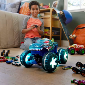 Hot Wheels Monster Trucks Mega Wrex Alive RC with glowing wheels and interactive lights played by a child indoors.
