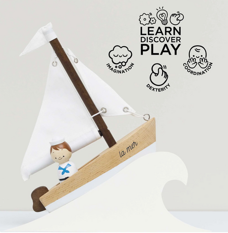 Sail Boat & Captain wooden toy with cotton sails and a painted sailor figure promoting imaginative play for ages 2 and up.