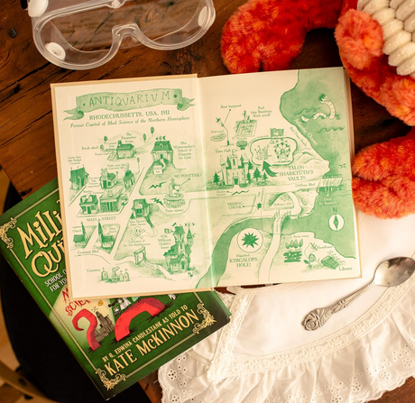 Open illustrated map of Antiquarium from The Millicent Quib School of Etiquette for Young Ladies of Mad Science displayed with safety goggles and book.