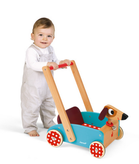 Toddler pushing the Crazy Doggy Cart wooden toy with felt ears and ringing bell for ages 1 to 4 years old.