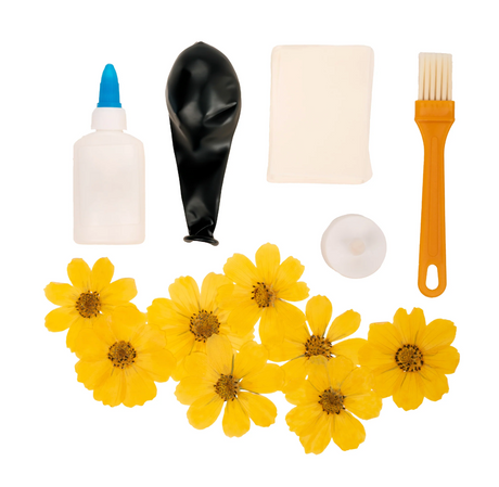 Crafters Flower Paper Lamp kit with glue, black balloon, tissue paper, brush, dried yellow daisies, and tealight votive.