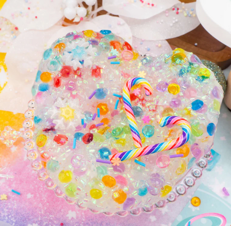 Candy Cane Crush Crunchy Slime with colorful beads and two striped candy cane decorations in a heart-shaped container