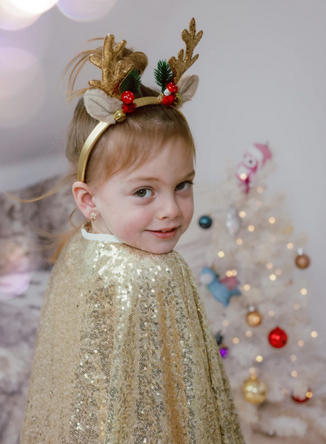 Holiday Rudolph Headband with gold sequin antlers, bells, mushrooms, and evergreen worn by smiling child in festive setting