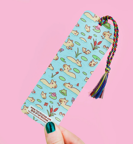 Bookmark Reading Makes Me Capy with cute capybara and rainbow tassel on premium matte cardstock, 2 by 6 inches.