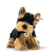 Yorkshire Terrier Herkules plush toy with black and gold silky fur, floppy, soft, and handmade by Steiff artisans.