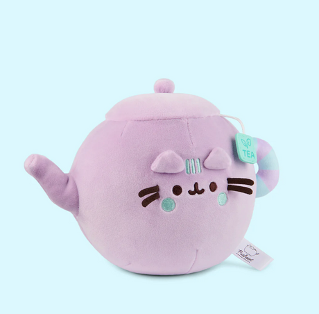 Pusheen Tea Pot plush in lilac with teal details, soft and squeezable with a cute teabag tag and cat face design.