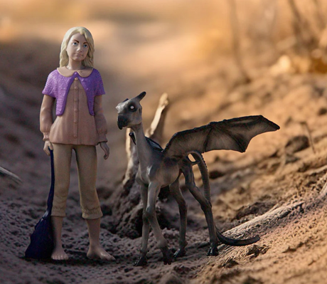 HP Luna Lovegood & Baby Thestral figurine showing Luna in casual clothes with a magical Thestral creature by her side.