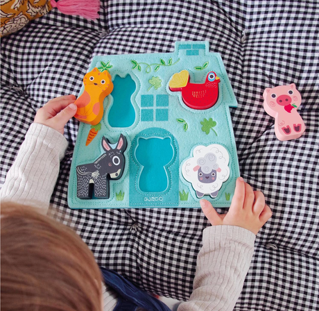 5pc Mouki Puzzle with colorful wooden farm animals and soft felt base, perfect for toddlers aged 12 months and up.