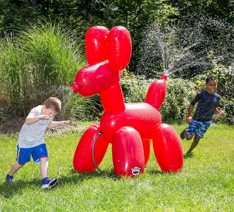 Sprinkler | Balloon Dog inflatable water toy spraying from head and tail with kids playing outdoors in backyard.