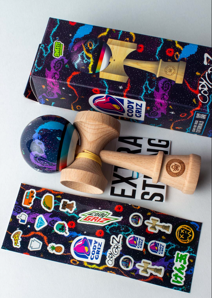 Kendama Cody Griz Signature with vibrant galaxy design, wooden body, and included stickers and packaging.