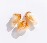 Three natural Rock | Citrine Point crystals with warm golden hues and clear quartz tips on a white background.