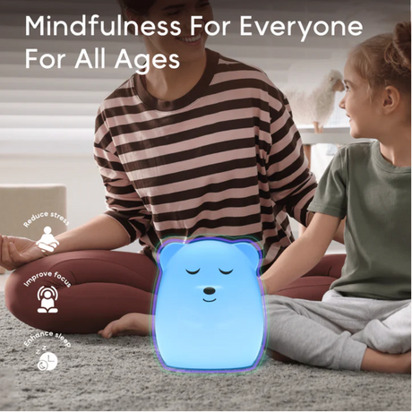 Breathing Pal | Ted the Bear glowing blue between adult and child practicing mindfulness and relaxation.