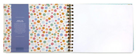 Artist Sketchbook | Flora open to blank page, showing colorful floral patterned inside cover and spiral binding.