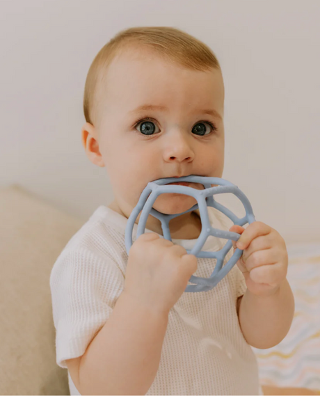Baby chewing on Soft Blue Sensory Ball from Sensory Ball 2 Pack, safe food-grade silicone teether toy for early development.