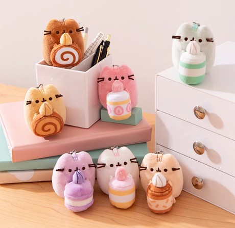 Pusheen Patisserie Blind Box plush keychain collection featuring Pusheen holding assorted dessert cakes in pastel colors.