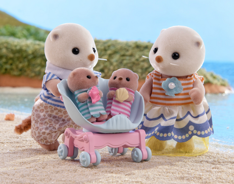 Sea Otter Family with mother and father figures, two babies in shell pram, and detailed outfits by the water.