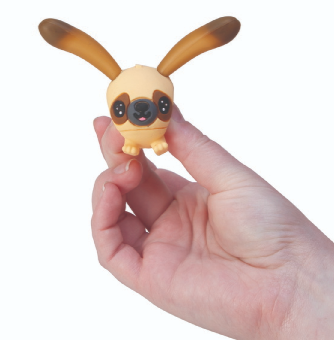 Hand holding Perk Ups! toy with long floppy ears perked up, small and adorable puppy figure.
