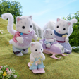 Snow Leopard Family figurines with two adults and two cubs playing outdoors on skis and a sled.