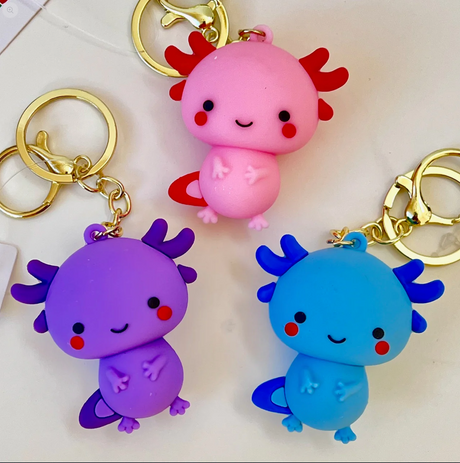 Axolotl Figurine KeyChain in assorted pink, purple, and blue colors with playful smiling faces.