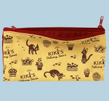 Kiki's Delivery Service Pen Case with Jiji and bakery print on yellow canvas, featuring a deep red zipper and interior lining.