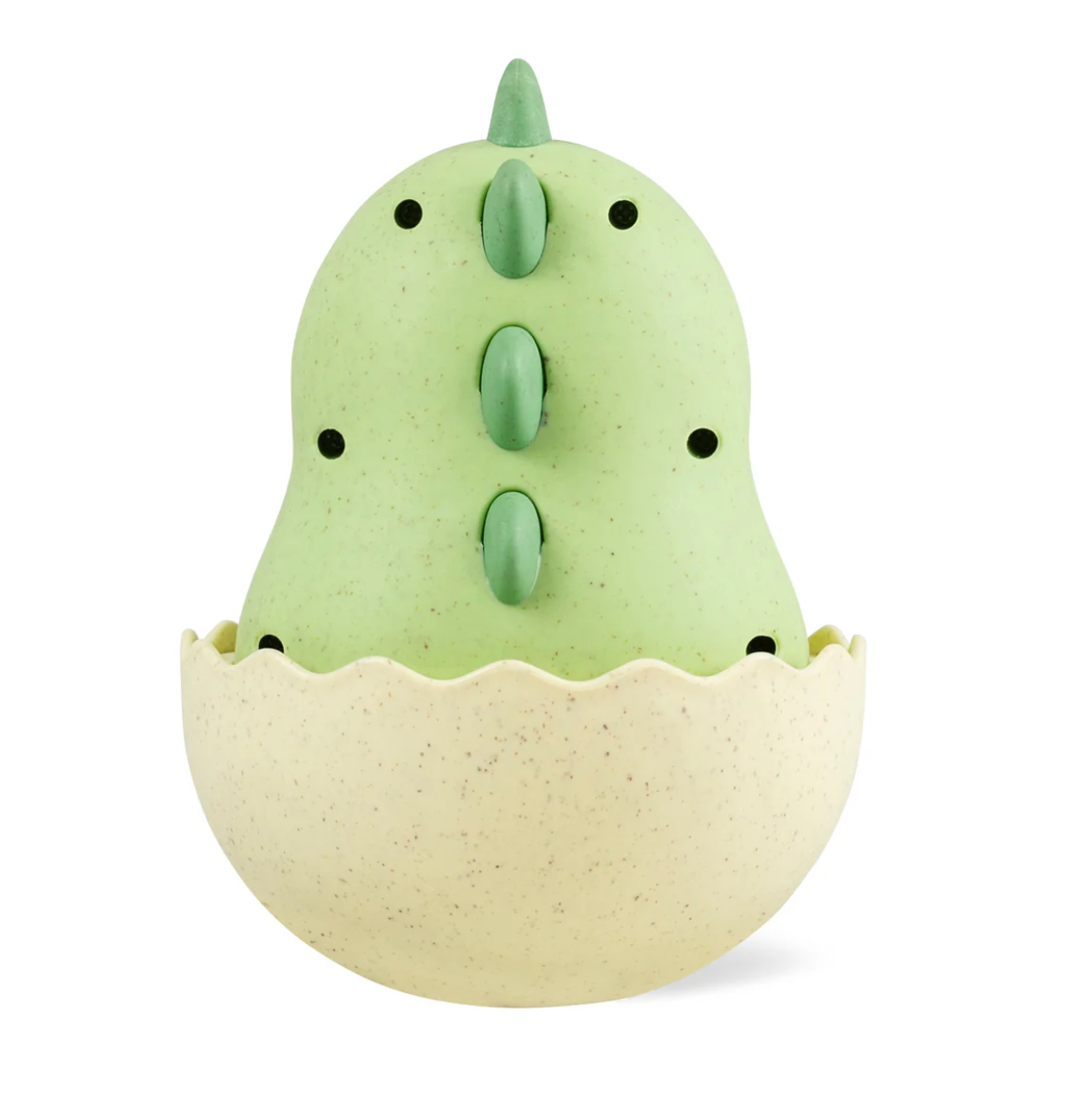 Roly Poly Dino baby toy in green with textured back frills sitting in beige egg shell for sensory play and crawling development.