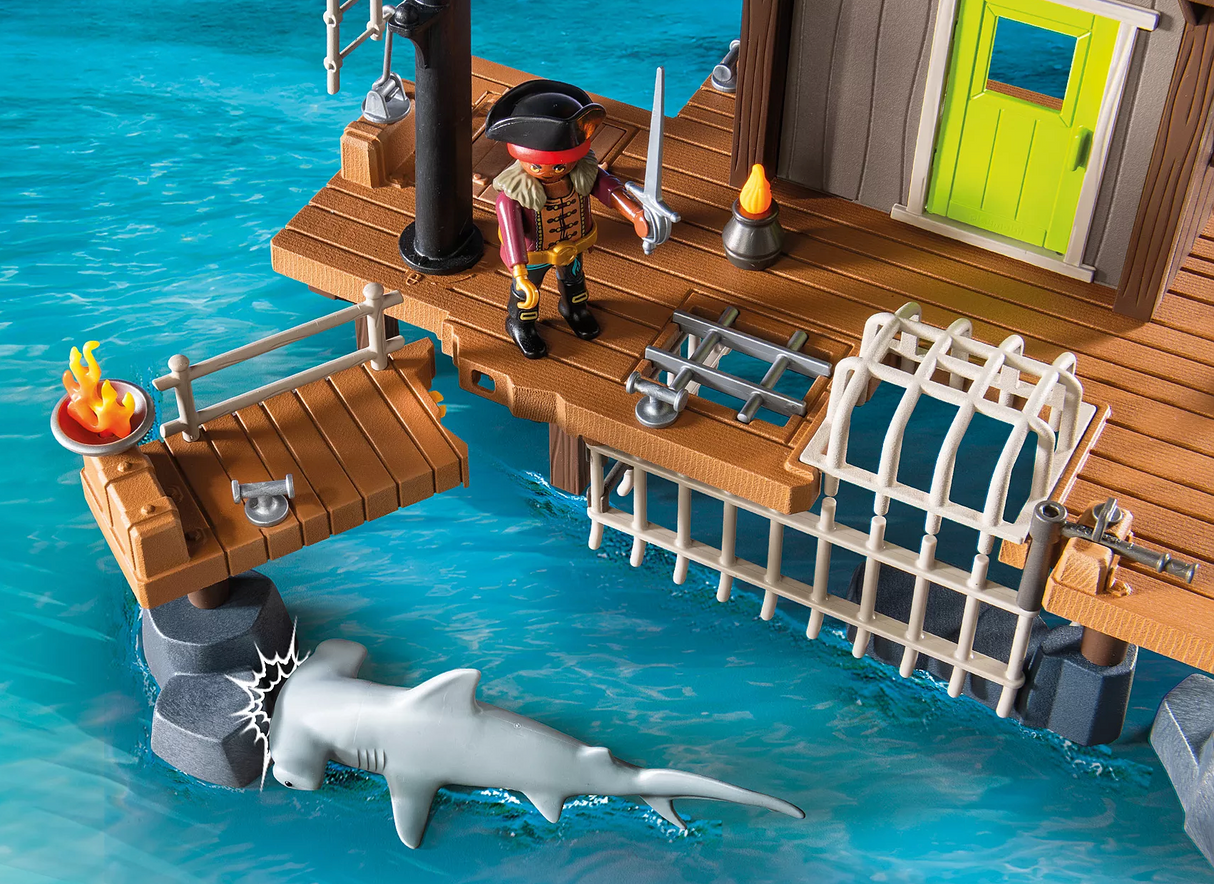 Pirates | Pirate Harbor PLAYMOBIL set with pirate figure, dock, shark in water, and prison cage beneath guardhouse.