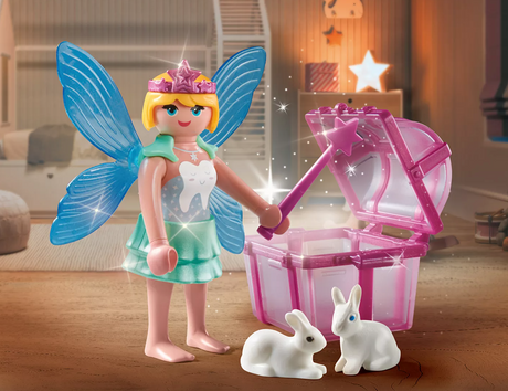 Special Plus | Tooth Fairy figure with blue wings, magic wand, pink tooth box, and two white rabbits on wooden floor.