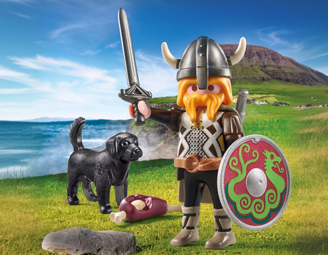 Special Plus | Viking with Guard Dog PLAYMOBIL figure holding sword and shield with dog and meat bone in outdoor setting.