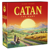 Catan 6th Edition board game box featuring a vibrant sunrise over a lush, hexagonal landscape with settlers and sheep.