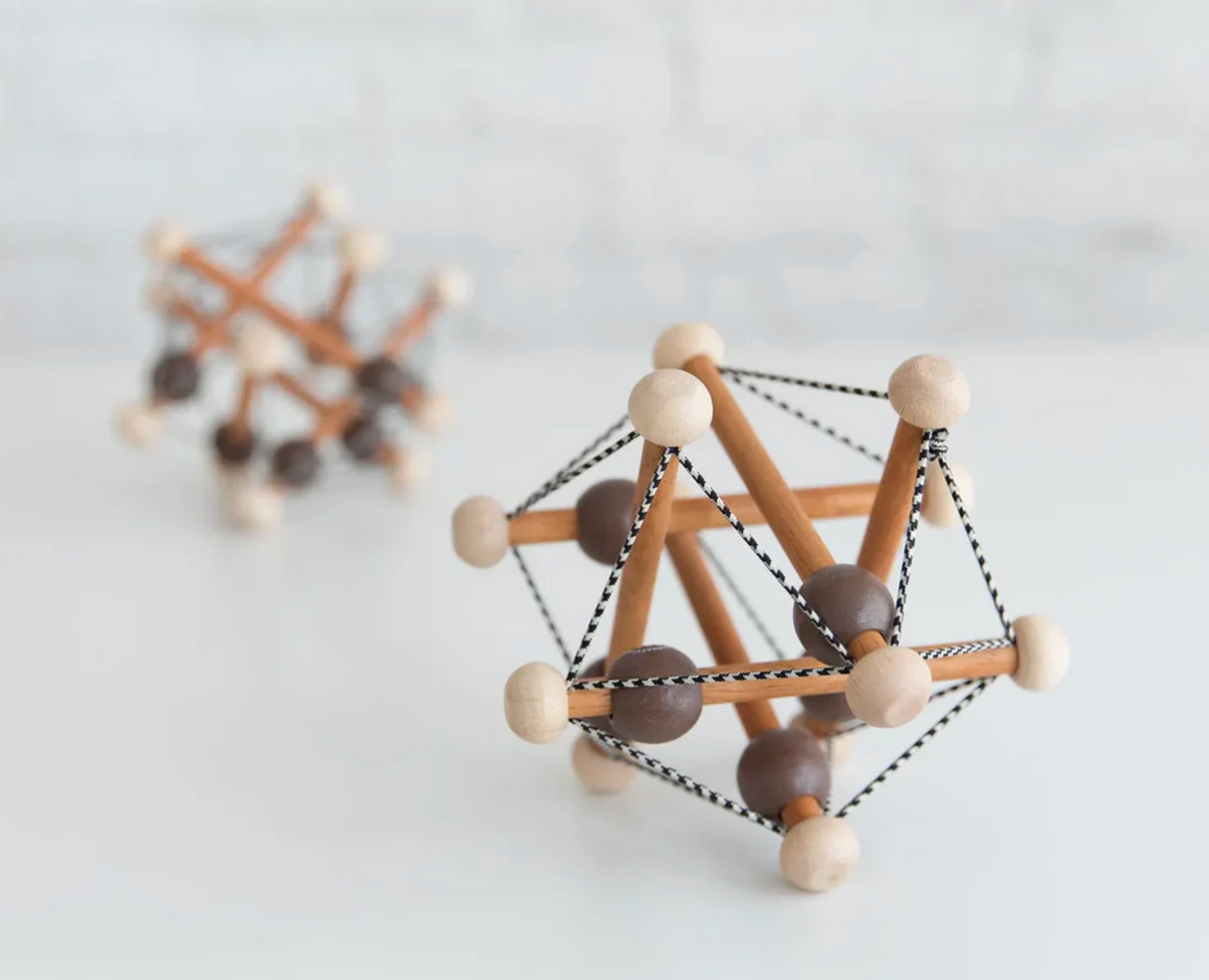 Skwish | Artful wooden infant toy with elastic strings and beads that slide and rattle for sensory play and motor skills.