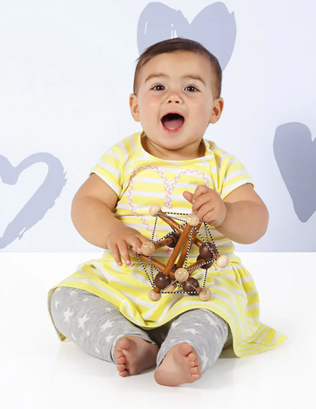 Baby playing with Skwish | Artful wooden sensory toy with elastic and sliding beads for infant development.