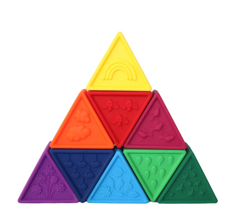 Triblox | Rainbow pastel-colored textured triangular blocks arranged in a pyramid for sensory and educational play.