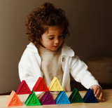 Child playing with colorful pastel triangular blocks featuring numbers and textures, Triblox | Rainbow for learning.