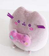 Pusheen Gamer plush in soft purple holding a bright pink controller with embroidered details, perfect cute gaming partner.