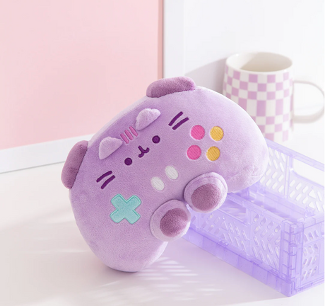 Pusheen Gamer: Controller plush toy in soft lavender with colorful buttons and embroidered cat face, perfect for gamers.