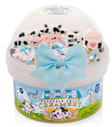 Glossy white slime with cow, milk carton, and bottle charms in a decorated container with a blue bow