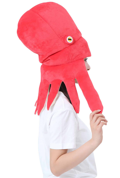 Person wearing a bright red octopus hat with plush tentacles and cartoon-style eyes on the side.