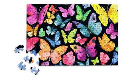 Colorful butterflies with vibrant wings on a completed 150-piece micro puzzle against a black background