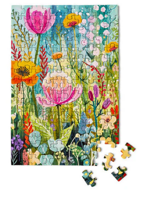 Colorful floral garden scene made of 150-piece puzzle with vibrant pink, orange, yellow flowers and green leaves.