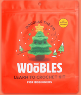 Bright orange package featuring Douglas the Fir crochet tree with star, eyes, and smiling face for beginner kit