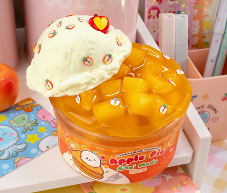 Clear golden jelly slime with apple cube pieces topped with white cream slime decorated with tiny apple designs