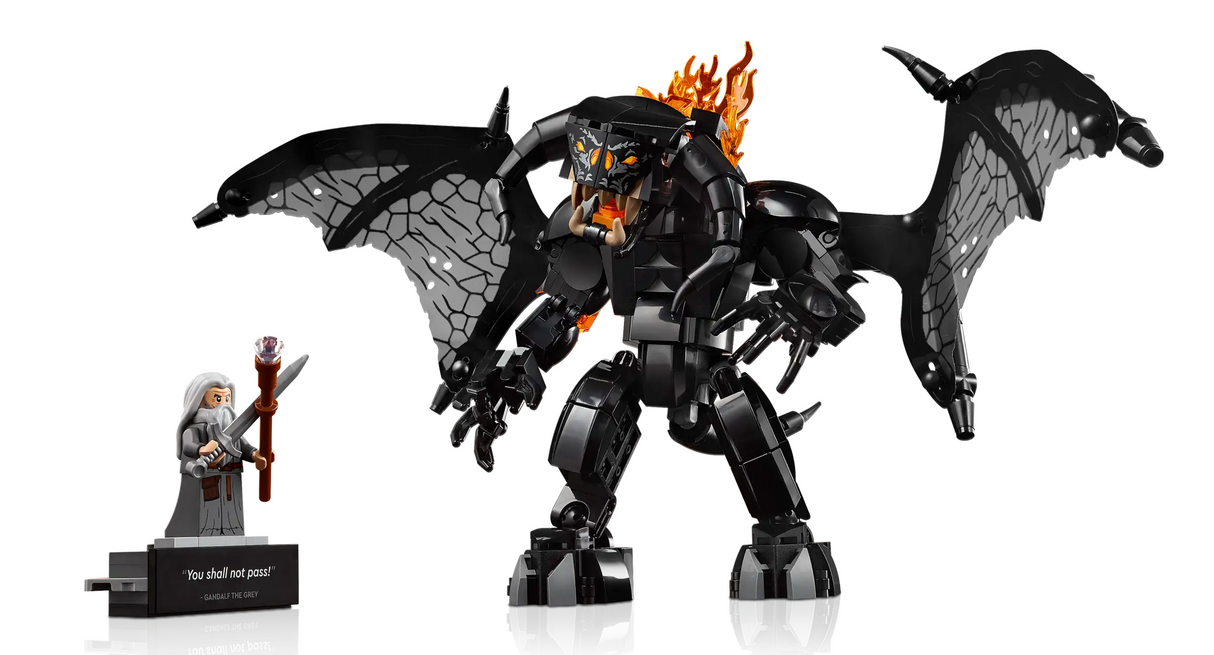 LEGO model of Gandalf facing the fire-breathing Balrog with flames and large textured wings on display.