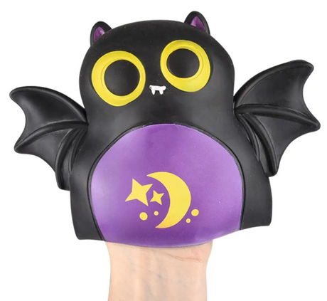 Soft black bat rubber puppet with yellow eyes and purple belly featuring moon and stars design on hand
